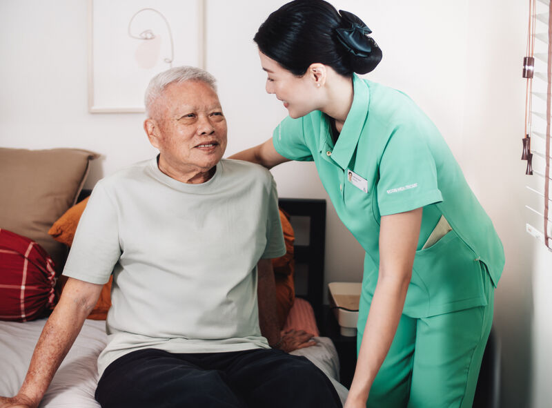 Caregiver with resident at bedside