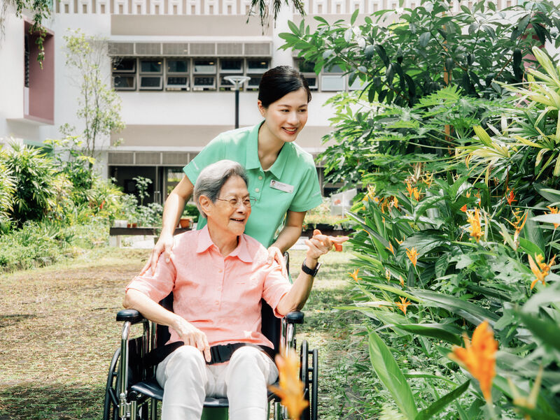Caregiver with resident in garden