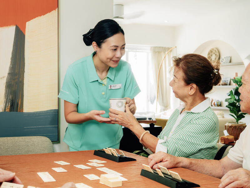 Caregiver serving tea during activities